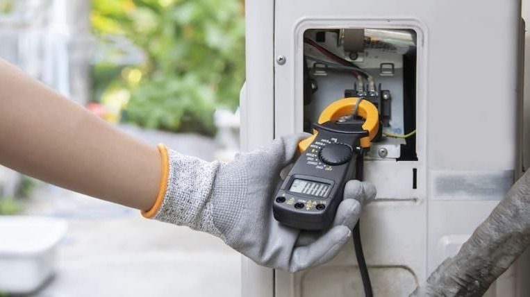 HVAC technician performing AC maintenance